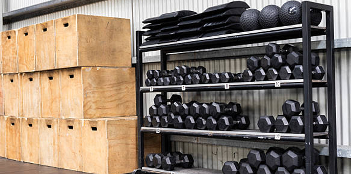 Close up of heavy dumbbells on a rack in a professional sports facility