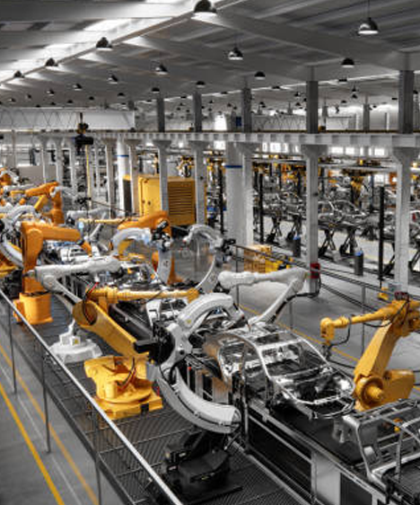 Industrial factory floor with robotic arms and machinery