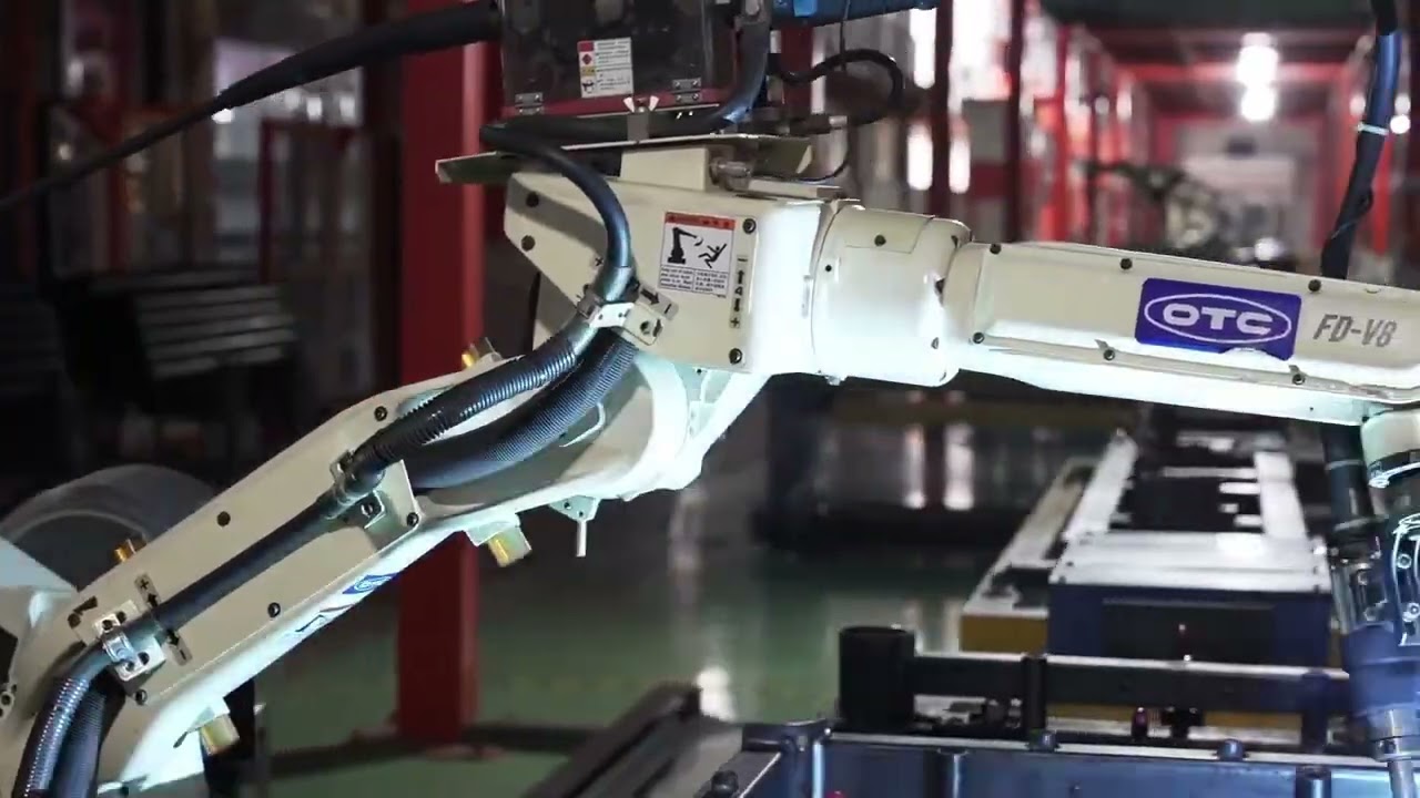 A robotic arm operating in a manufacturing facility, tinted purple