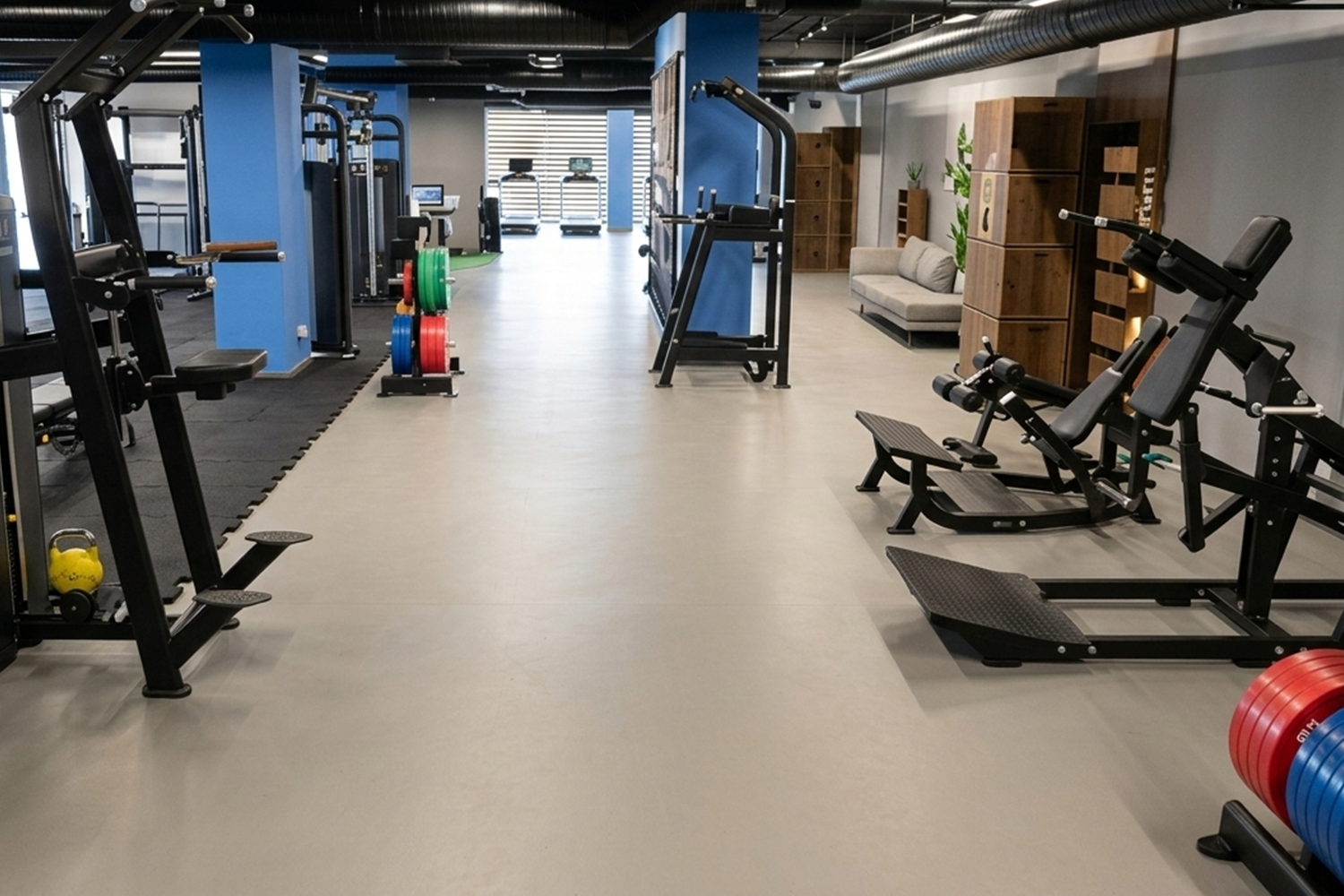 Interior of a commercial gym with black and gold strength equipment