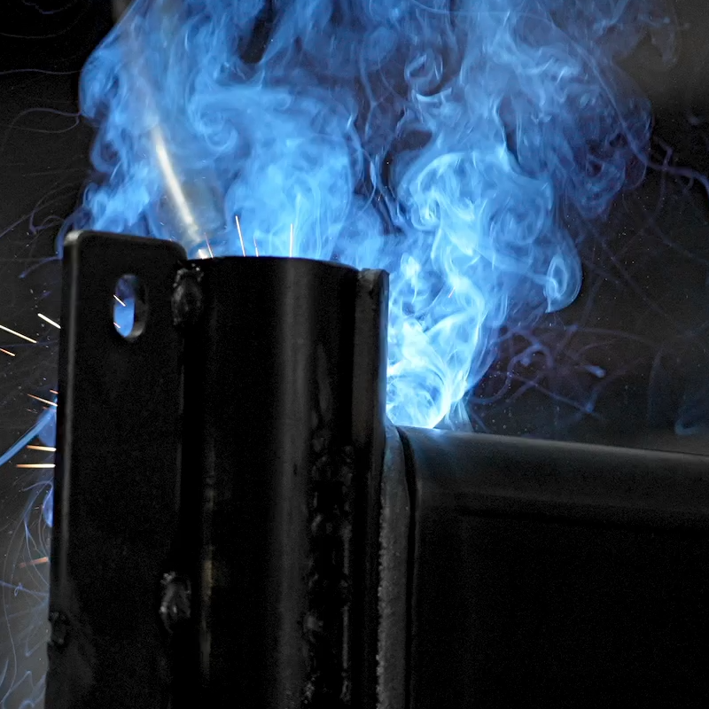 Close up of blue welding sparks on metal tube