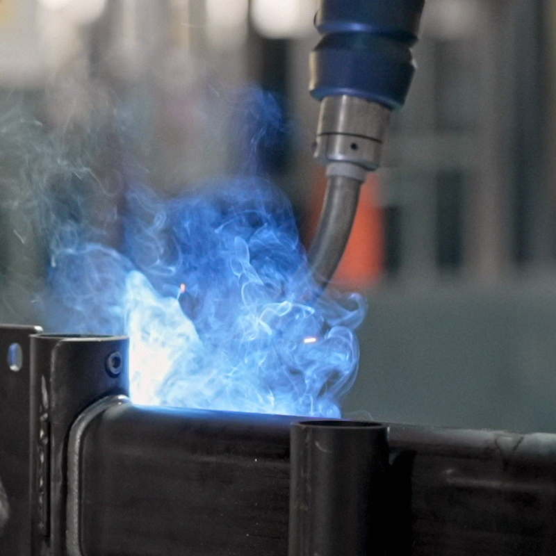 Close up of bright blue sparks from laser welding metal