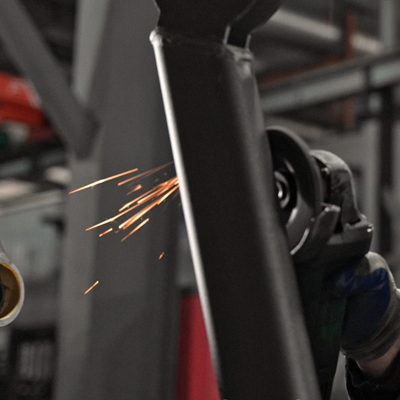 Close up of orange sparks flying from a metal grinding process