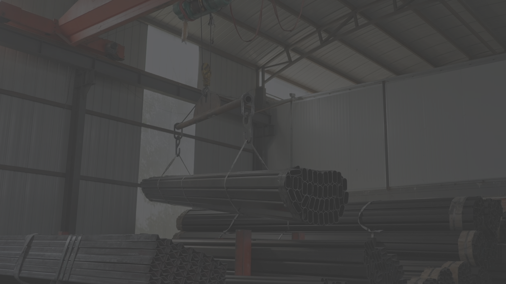 Wide shot of the interior of a large manufacturing facility with steel structures